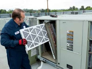 HVAC technician changing an air filter