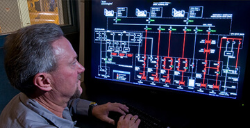 Technician working on Building Automation software for a custom BAS project